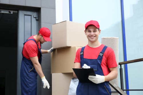 Team carrying furniture through an apartment building in St Johns Wood