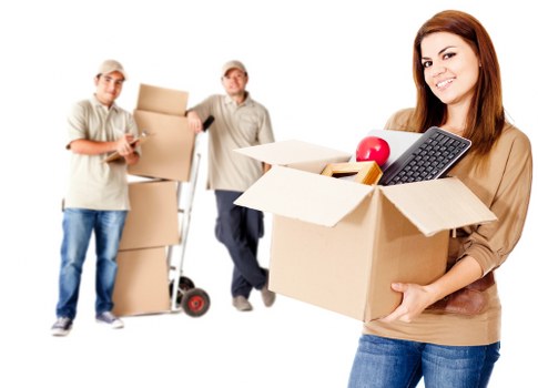 Professional movers handling desks and office furniture carefully